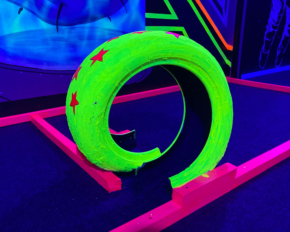 4th Hole: a decorated neon tyre forms a loop the loop